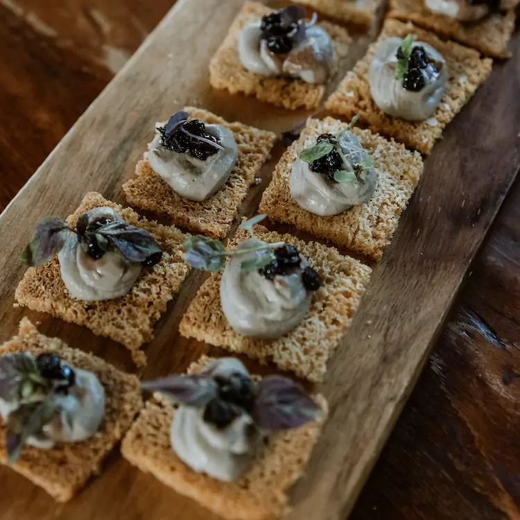 Roaming savoury canapes on a wooden platter