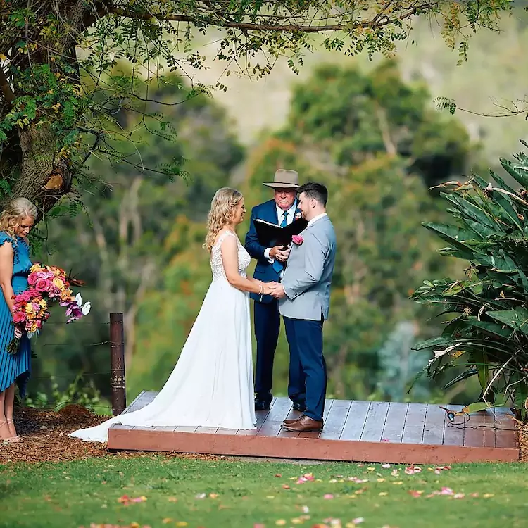 Bride and groom reading their vows in the garden