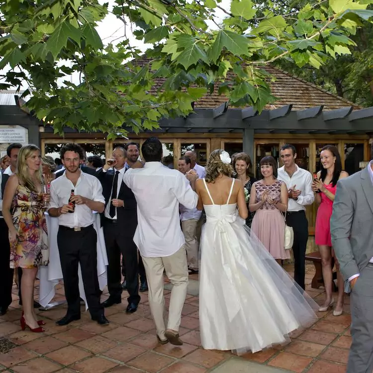 Bride and groom walking through our courtyard for their wedding reception